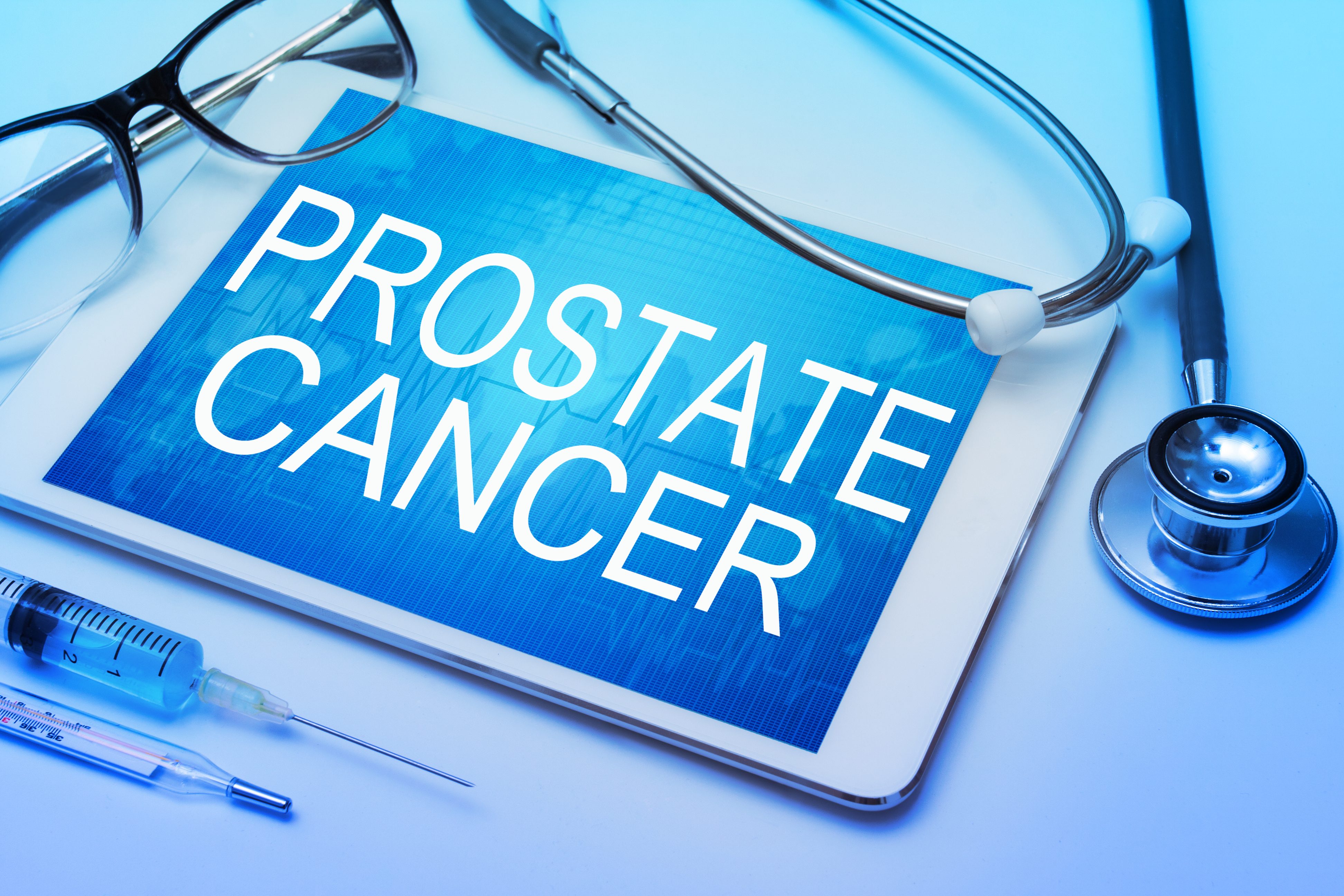 Prostate Cancer word on tablet screen with medical equipment on background